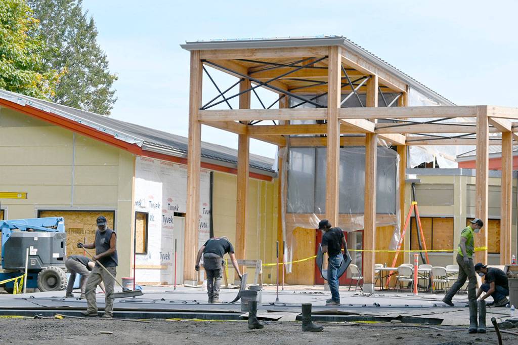 Construction continues at the newly-renamed Dungeness River Nature Center in late August. Workers with Hiday Concrete, Inc., work on the patio that will more than double the original outdoor entrance space, river center officials noted last week. The center, undergoing a multi-million-dollar expansion, is expected to reopen this fall. Sequim Gazette photo by Michael Dashiell