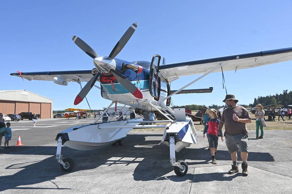 Norm Nelson and 10-year-old Nathan Nelson get a look at an amphibious plane outfitted with Aerocet composite floats at the eighth Olympic Peninsula Air Affaire and Fly-In Saturday afternoon in Sequim. It was his familys first Air Affaire visit. 
Sequim Gazette photos by 
Michael Dashiell