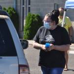 Heather Baker, art room director at the Sequim Boys & Girls Club, greets attendees and hands out supplies at the 2021 Back to School Fair on Aug. 28. Sequim Gazette photo by Michael Dashiell