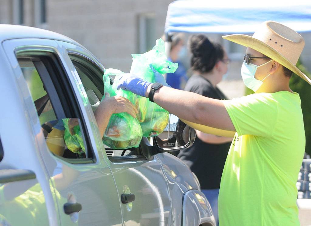 Gabriel Allen hands out free lunches to attendees of the 2021 Back to School Fair on Aug. 28. Sequim Gazette photos by Michael Dashiell