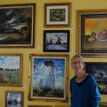 Carrie Rodlend plans to auction off more than 30 reimagined classic paintings, such as Claude Monets Woman with a Parasol – Madame Monet and Her Son on Saturday, Sept. 11 from her home studio at 562 Holgerson Road in Dungeness. Shes worked more than a year beside her students on reimagining classic paintings to teach new techniques. Sequim Gazette photo by Matthew Nash