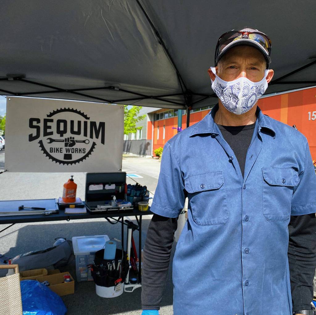 Nathan Van Laningham welcomes visitors to the Sequim Bike Works booth at the Sequim Farmers & Artisans Market. Photo by Emma Jane EJ Garcia