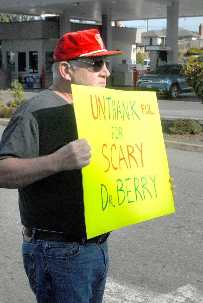 Jerry Ludke holds a sign admonishing Dr. Allison Berry, the health officer for Clallam and Jefferson counties, during a rally against vaccine mandates on Sept. 3 in Port Angeles. Photo by Keith Thorpe/Olympic Peninsula News Group