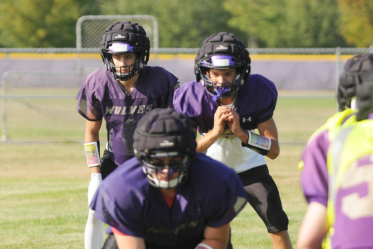 Sequim quarterback Kobe Applegate, right, and running back Aiden Gockerell await a snap in a preseason practice. The Wolves home opener on Sept. 10 against Squalicum is in jeopardy. Sequim Gazette file photo by Michael Dashiell