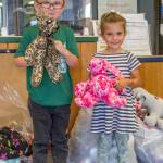 Nick, age 5, and Josie, age 4, of Great Futures Preschool, a program housed at the Sequim Boys & Girls Club, hold stuffed animals sewn by members of the Sequim Fiber Arts Neighborhood Group of the Sewing Guild of America for distribution at the club. Sequim Gazette photo by Emily Matthiessen