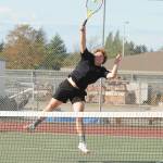 Sequims Kaiden Jones reaches for an overhead slam in a straight-set win with partner Espn Judd over Bremertons Nico Crowley and Nate McClain on Sept. 9. Sequim Gazette photo by Michael Dashiell