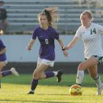 Port Angeles Anna Petty left, looks for running room and a teammate as Sequims Zoe Moore gives chase in an Olympic League season-opener for both teams on Sept. 9. Sequim Gazette photo by Michael Dashiell