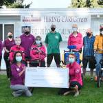 In front row, co-owner Kathleen Schmidt of Home Instead of Clallam & Jefferson Counties (left) delivers a check worth $7,808 to Sequim Wheelers Nicole Lepping on Sept. 9, following the annual Home Instead Charities GIVE65 fundraiser held in July. Joining the pair are (back row, from left) Kim Cleary, Trisha Rodgers, Jade Downer and co-owner Isaac Schmidt of Home Instead, and Sequim Wheelers Bob Fitton, Leilani Sundt, Norm Hieger and Marcia Wesesky, with (middle row, from left) Wheelers Michele Fraker and Lanie Cates. Sequim Gazette photo by Michael Dashiell
