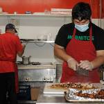 Julian Hernandez, right, cuts chicken meat as Jose Garcia preps a meal on Tuesday at Joses Famous Salsa. The business was recently highlighted on <a href="https://www.king5.com/article/entertainment/television/programs/evening/joses-famous-salsa-sequim/281-7a5d6069-cf28-4ec1-be01-d25ca4511605" target="_blank">King5s Evening </a><a href="https://www.king5.com/article/entertainment/television/programs/evening/joses-famous-salsa-sequim/281-7a5d6069-cf28-4ec1-be01-d25ca4511605" target="_blank">program</a>. Sequim Gazette photo by Matthew Nash