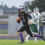 Sequims Kobe Applegate races to the end zone on a 46-yard touchdown reception from quarterback Lars Wiker as Port Angeles Beckett Jarnagin looks on. Sequim Gazette photo by Michael Dashiell