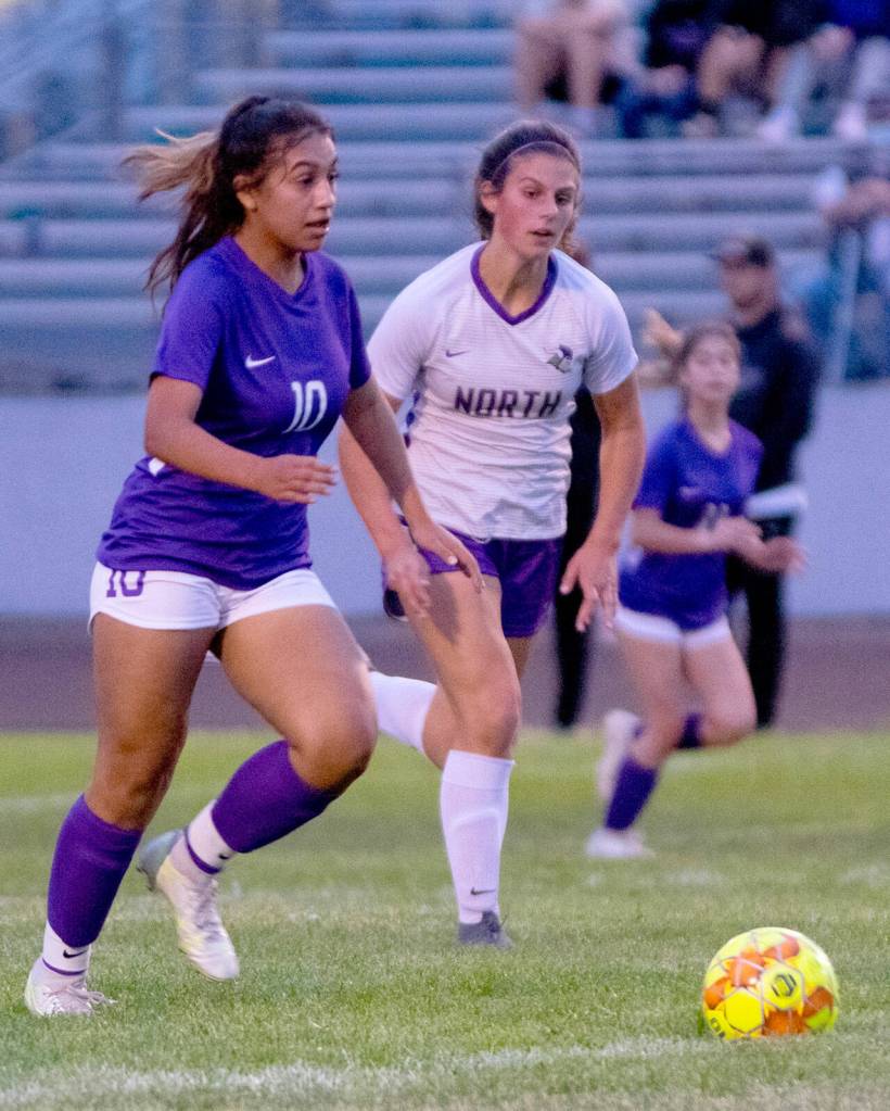 Sequims Jennyfer Gomez, left, advances the ball in the first half of the Wolves 2-0 win over visiting North Kitsap on Sept. 16. Sequim Gazette photo by Emily Matthiessen