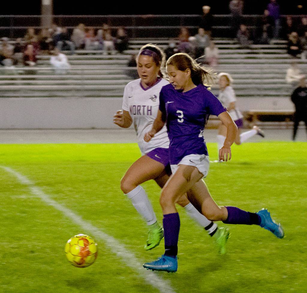 Sequims Taryn Johnson, right advances the ball into North Kitsap territory in the Wolves 2-0 win over North Kitsap on Sept. 16. Sequim Gazette photo by Emily Matthiessen