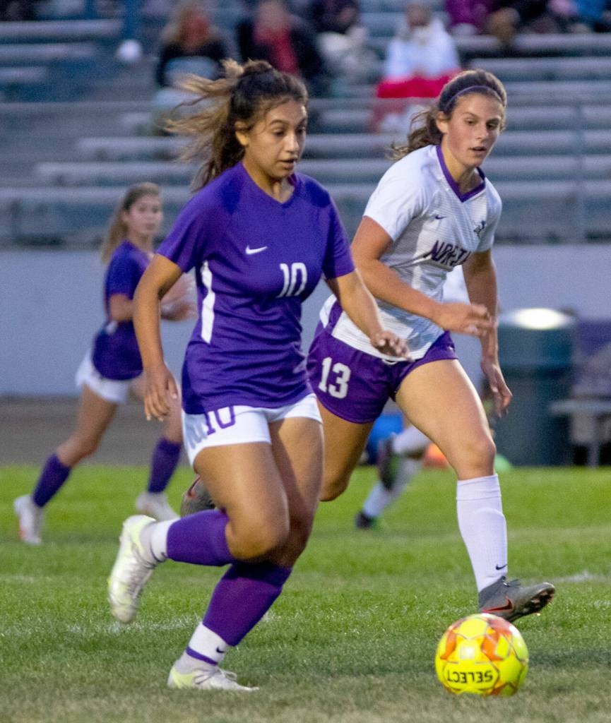 Sequims Jennyfer Gomez, left, advances the ball and is guarded by North Kitsaps Sydnee Hogan, in Sequims 2-0 home win on Sept. 16. Sequim Gazette photo by Emily Matthiessen