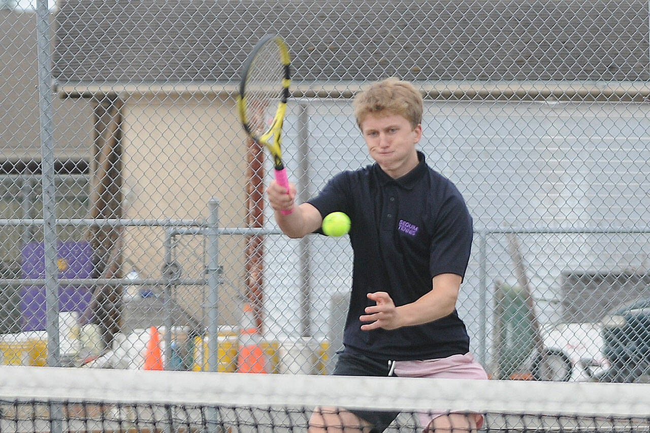 Sequims Jack Van De Wege hits a forehand winner as he and teammate Henry Hughes top Olympics Jonathan Mourich and Chris Posis in straight sets (6-0, 6-1) on Sept. 22. Sequim Gazette photo by Michael Dashiell