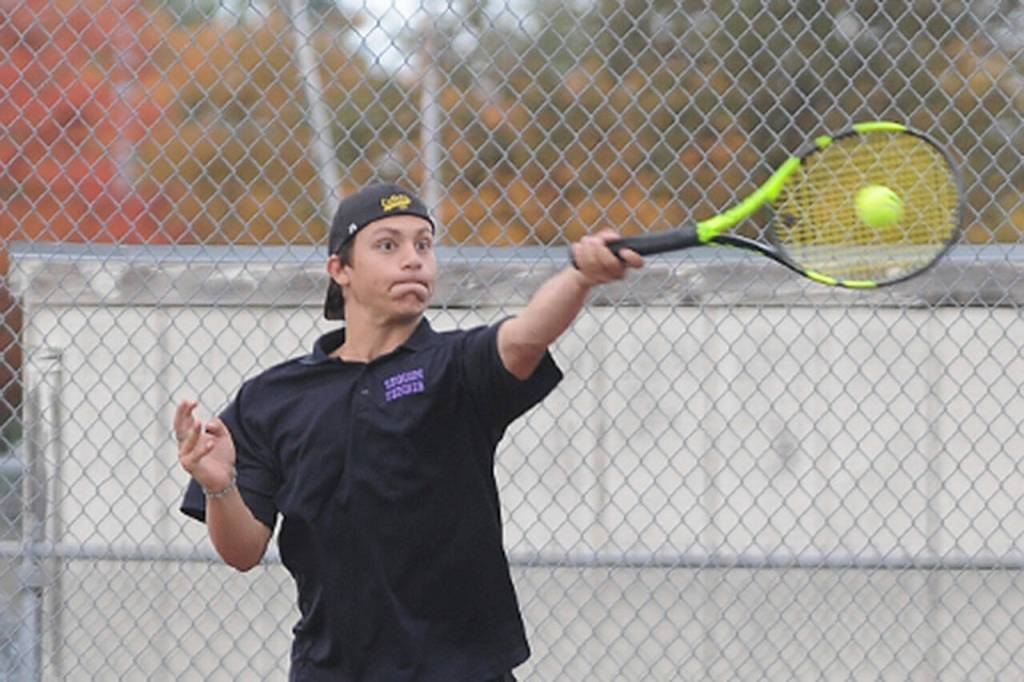 Sequims Espn Judd rips a forehand volley as he and teammate Kaiden Jones take on Olympics Warner Alexander and Freddy Enamorato on Sept. 22 in Sequim. Jones and Judd won, 6-2, 6-1, as the Wolves swept the Trojans 7-0. Sequim Gazette photo by Michael Dashiell