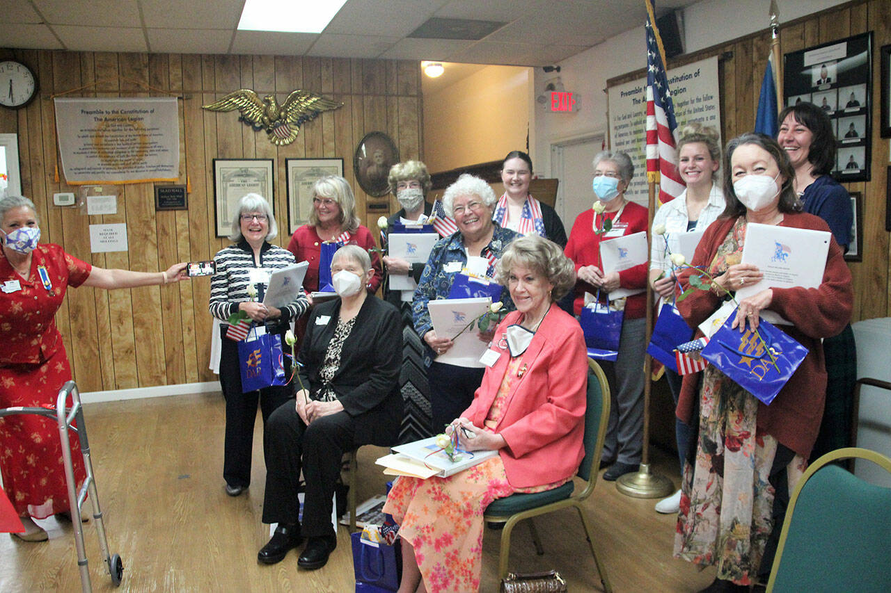 Pictured, from left, is Michael Trebert Chapter regent Judy Tordini holding the zoom connection where two members  Susie Johnson in Sequim and Meg Best in Arizona  take the the Oath of the National Society of Daughters of the American Revolution remotely on Sept. 14. Tordini is pictured with (standing, from left) new members Diane Cox, Kristine Konopaski, Janet Abbott, Joan Bennett, Erika Burton, Pat Chambers, Greta Christianson, Amira-Lee Salavati and Lee McGill, with (sitting, from left) Sandra Ristow and Nan Heathers. Submitted photo