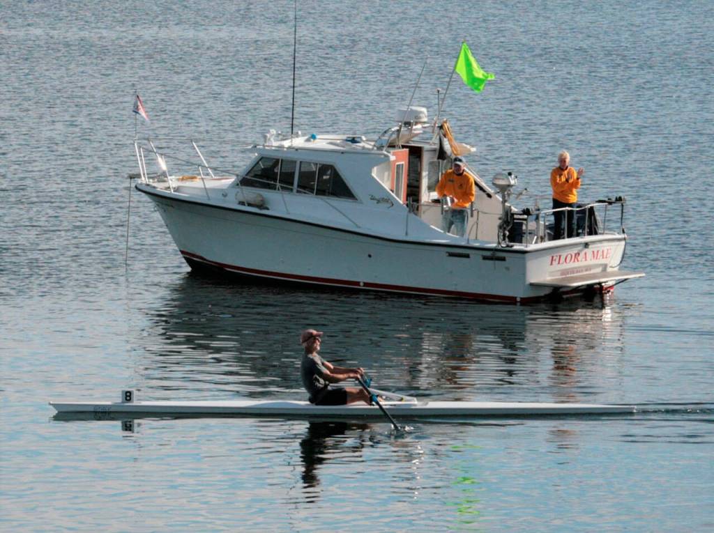 Ron Moller of Port Townsend crosses the finish line in first place, clocking in at 52:38.4. Photo by Dennis Miller