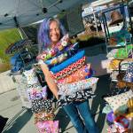 KarenLynn Robinson displays some of the BlissPillows she offers at her booth at the Sequim Farmers & Artisans Market Saturday. Photo by Emma Jane EJ Garcia