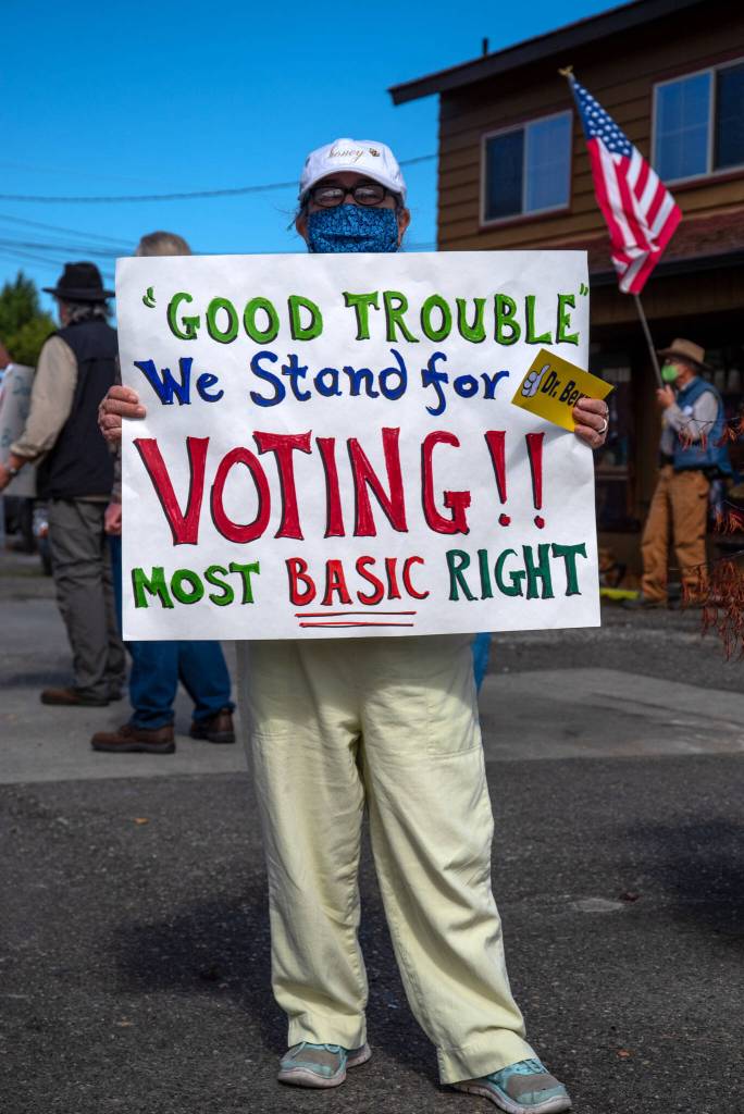 Honeybee Burns holds a sign to remind citizens of the right to vote at a rally in Sequim on Sept. 18. Burns says that her family has a long history of seeking societal improvement and equity for all citizens. Sequim Gazette photo by Emily Matthiessen