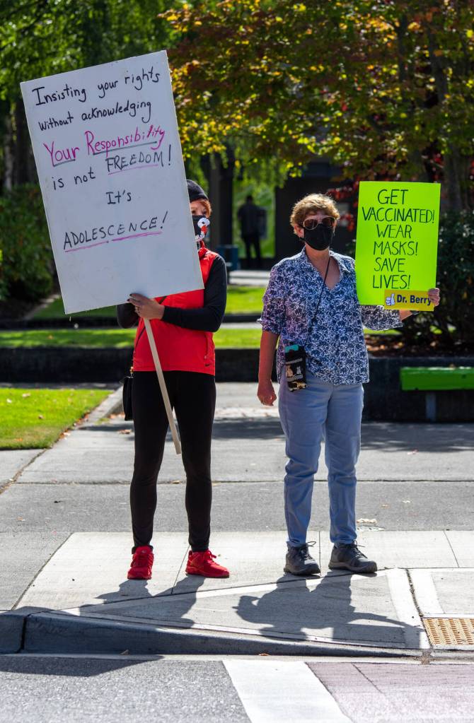 I want life to get back to normal, said Natalie Elfant, holding a green sign on the right, and we cant do that until people get vaccinated and get rid of COVID and its variants. She and Pauline, left, attend a rally in Sequim on Sept. 18. I was in the military for 27 years, said Pauline, and I served my country and I really put my life on the line for the citizens of the United States…. why cant we do something simple like wear a mask or get one vaccine to save other lives? Thats all we have to do. Sequim Gazette photo by Emily Matthiessen