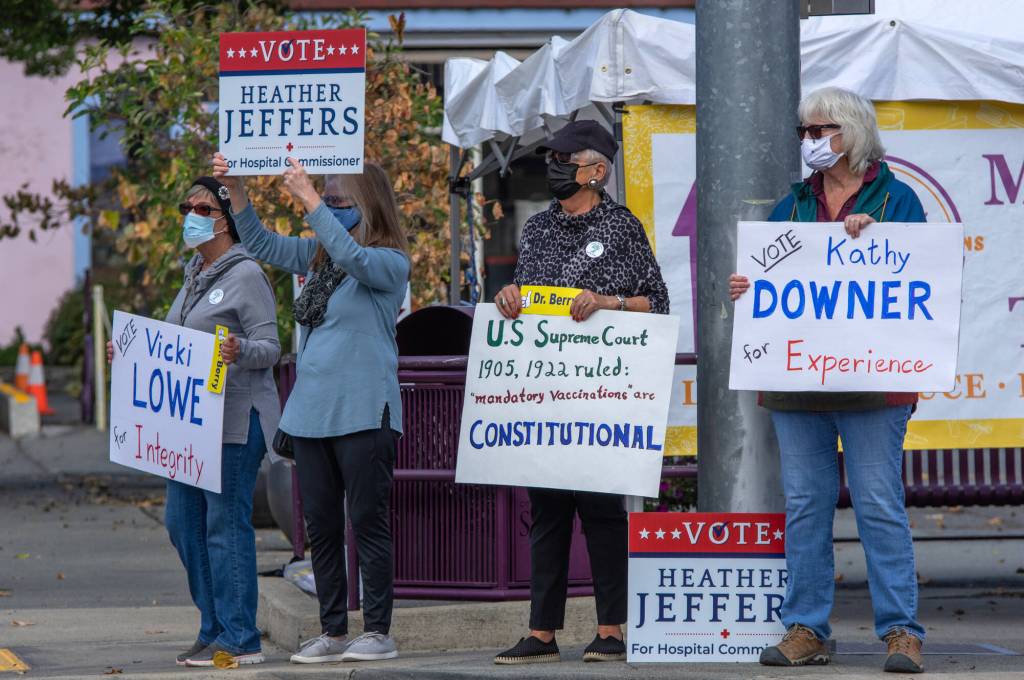 Attendees of a rally in Sequim on Sept. 18 hold signs supporting their favorite candidates for local office. Sequim Gazette photo by Emily Matthiessen