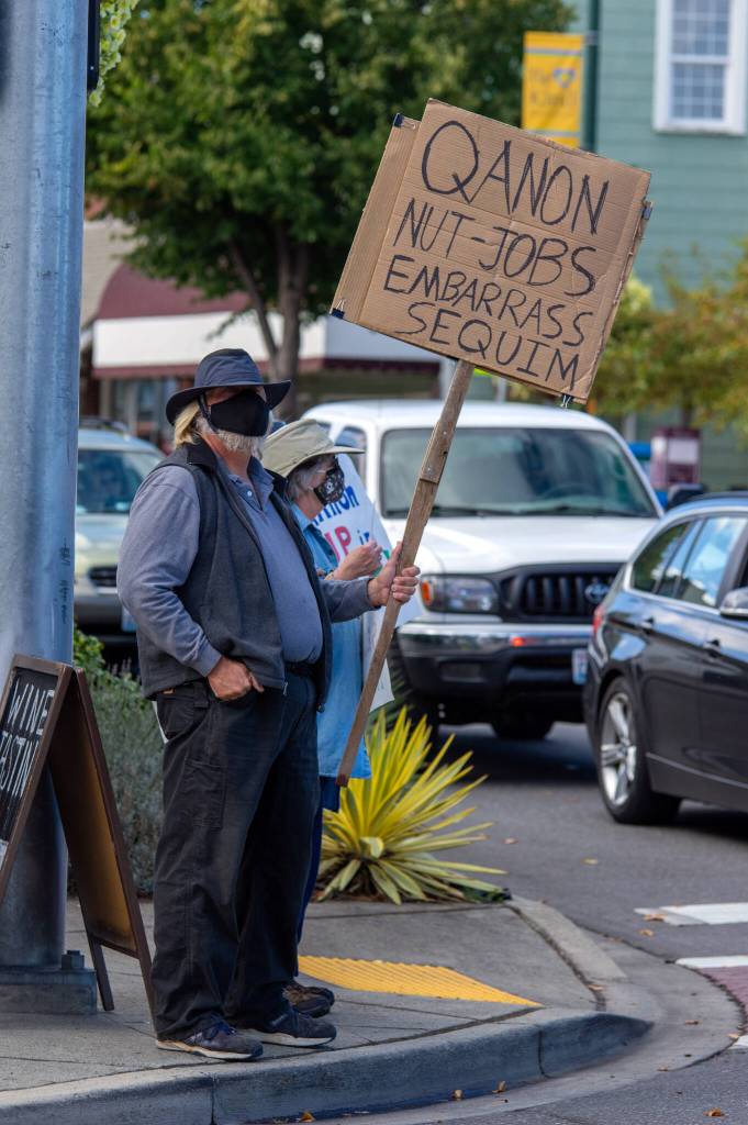 Richard Goette holds an anti-conspiracy sign on the corner of Washington St. and Sequim Ave. during a rally on Sept. 18 in Sequim. Were proud to be here in support of Dr. Allison Berry. We are very appreciative of everything shes done to protect our community.