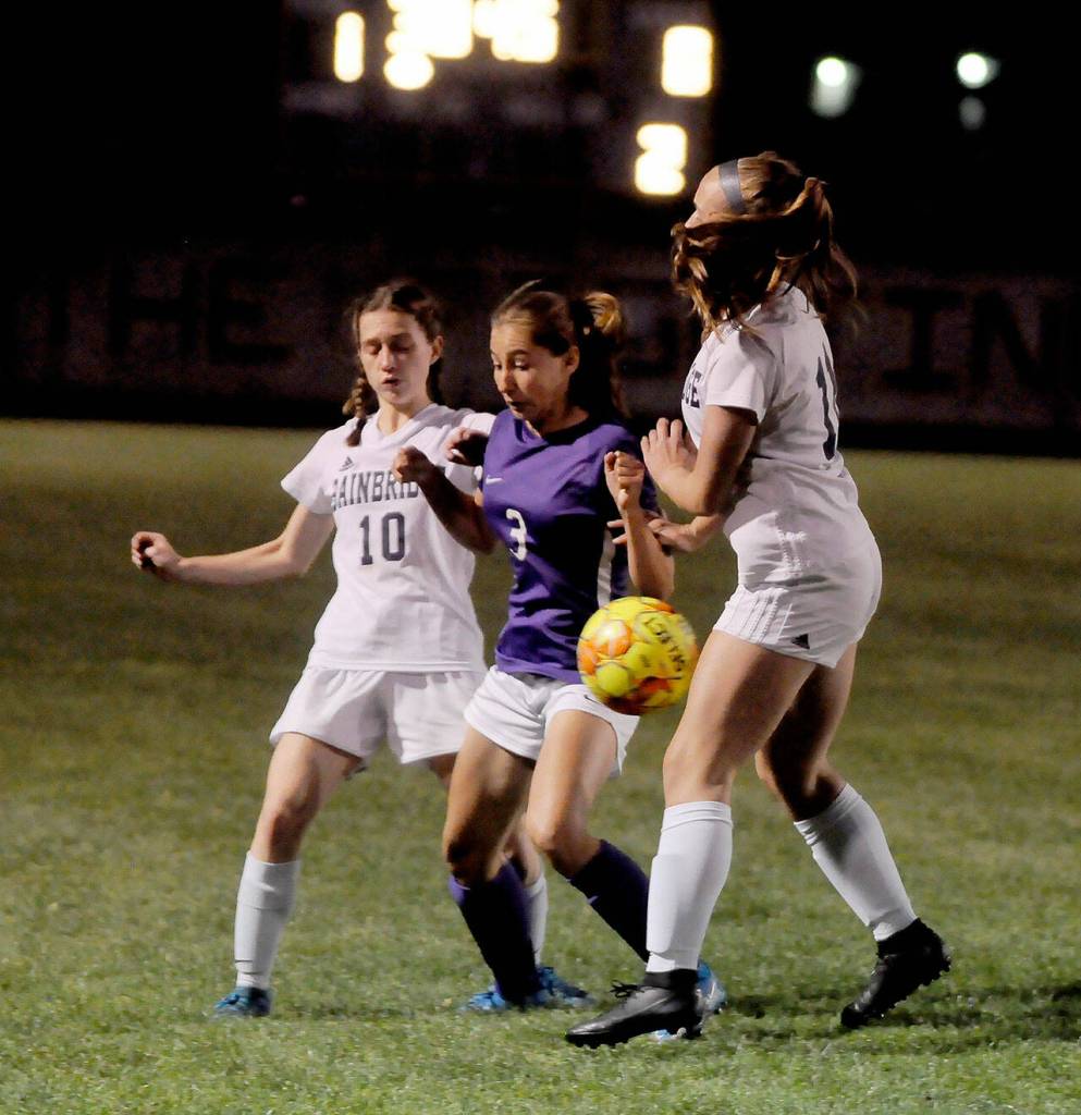 Sequim midfielder Taryn Johnson, center, vies for possession with Bainbridges Maddy Brown (10) and Ellie Murray (11) in the second half of the Wolves match-up with the 3A Spartans on Sept. 21. Sequim Gazette photo by Michael Dashiell