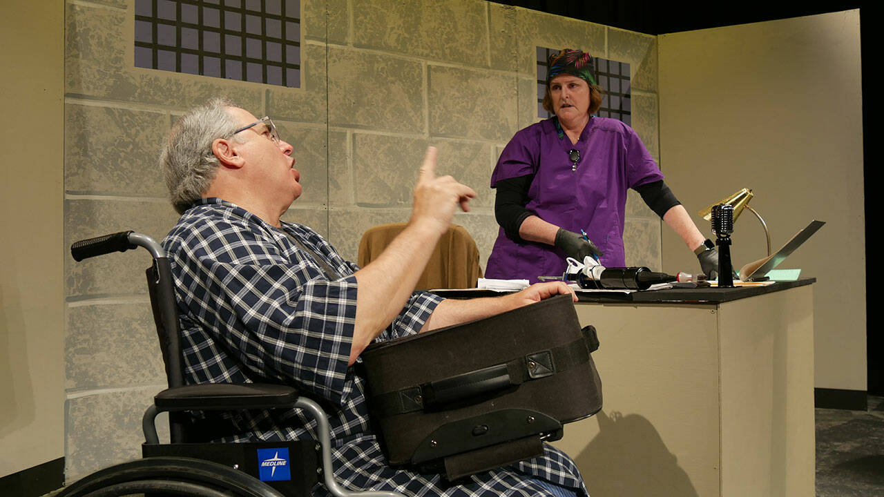 Joel Hoffman and Vicki Miller rehearse the arrival of Hoffmans trouble-making character in rehearsals of Olympic Theatre Arts A Facility for Living, a comedic production set to open Oct. 1. Photo courtesy of Olympic Theatre Arts
