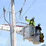 Workers from Clallam County PUD in August work on a project to bury power lines on Kirner Road. The effort, completed in September, will allow seasonal resident trumpeter swans to safely take off from nearby Kirner Pond. Sequim Gazette photo by Michael Dashiell