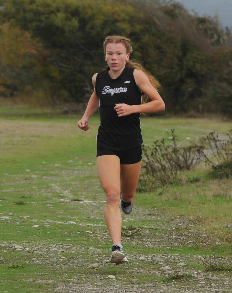 Sequims Riley Pyeatt leads the pack about midway through an Olympic League meet on Sept. 29 at the Dungeness Recreation Area. Pyeatt improved her time on the Sequim course from last years race by more than 20 seconds. Sequim Gazette photo by Michael Dashiell