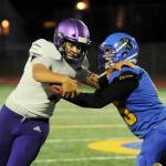 Sequim quarterback Lars Wiker, left, tries to avoid the grasp of a Bremerton defender in the Wolves 35-29 loss at Bremerton on Sept. 30. Sequim Gazette photo by Michael Dashiell