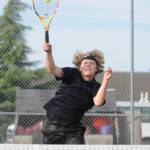 Sequims Kaiden Jones hits an overhead volley as he and Espn Judd take on North Kitsaps Carl Burchill and Ethan Gillespie on Oct. 4.
