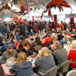 Crab festival attendees line up for crab dinners while others dine on a variety of sea food available in the main tent in 2019. File photo by Keith Thorpe/Olympic Peninsula News Group