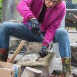 Suzan Mannisto chips away at old mortar during a restoration effort at Sequims Pioneer Memorial Park. Mannisto and her husband, Daniel Mannisto, took before and after pictures of the changes made by an all-volunteer crew in a fenced corner of the park.