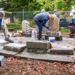 Volunteers work to improve the memorial corner created by Sequim Prairie Garden Club members in the 1960s at Pioneer Memorial Park. The history of the Garden Club and the park are intertwined, and from the beginning the club has cared for this 4 acre former cemetery with the aid of community members, turning it into the lush park off Washington Street that all residents and visitors can enjoy. The headstones in the memorial corner were fenced in the early 1980s due to vandalism that occurred through the years. Current members of the club requested that anyone in the community who may have a piece of one of the stones to please return it so they can piece together more of the headstones. Sequim Gazette photo by Emily Matthiessen