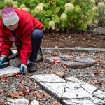 Karla Morgan cleans pieces of headstones broken by either vandalism, weather, or improper care in the more than 100 years they lay in Pioneer Memorial Park in Sequim. Morgan was one of many volunteers who gathered under the guidance of National Historical Preservationist Marion Mick Hersey to fix headstones using modern methods, some learned from The Good Cemeterian of Florida. Sequim Gazette photos by Emily Matthiessen