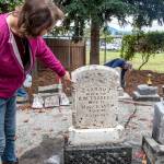 Suzan Mannisto points to the floral decoration on the headstone of Sarah Travers  the Sequim Prairie Garden Club may paint it next spring. According to Patricia Hudson, historian, Sarah was born in 1835 of French Indian parentage, and married Captain Robert Warren Travers in 1868 in Sequim. The couple had one son, George Warren Travers. Their only daughter, Margaret Jane, was born in 1870 at Port Williams, married Albert Edward Simmons on July 2nd, 1889 in New Dungeness, WA and died there on July 4th, 1953; they had 2 sons and 1 daughter. Sequim Gazette photo by Emily Matthiessen