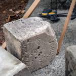 The joint headstone of John and Jane Govan, son and wife of John Govan, waits to be fitted to its proper base after being scraped of old white mortar by volunteers in Sequims Pioneer Memorial Park. This family did a lot with engineering roads, said Priscilla Hudson, historian of the Sequim Prairie Garden Club and Pioneer Memorial Park. The Govans were well-established in the public sector; they built roads and held important jobs in transportation. Jane and John were born in Scotland, as was their first son, John. They waited at a farm that had been in the family for 200 years until the baby was old enough to take the ocean voyage to the USA. They settled in Sequim after spending 3 years in Oregon. The couple had 8-10 children, but after their eldest, John, was killed at 25-years-old on New Years Eve, 1885 in Dungeness Bay, Hudson said Jane was overcome with grief, and took her own life in 1890. Sequim Gazette photo by Emily Matthiessen