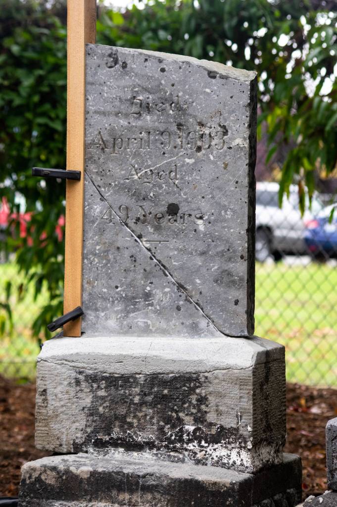 The headstone of J.F. Lowe was pieced together and repaired by members of the Sequim Prairie Garden Club and the Micheal Trebort branch of the Daughters of the American Revolution and other volunteers under the guidance of MarionMick Hersey, National Historical Preservationist. Lowe was born in 1854, died 1903, and was buried in the Sequim cemetery which became Pioneer Memorial Park. Sequim Gazette photo by Emily Matthiessen