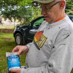 Marion Mick Hersey explains how to use a specific epoxy to affix headstones to basestones in a cemetery preservation. He said the epoxy would last forever. Hersey, National Historical Preservationist, came from Kitsap County to help other volunteers in a restoration effort at Sequims Pioneer Memorial Park. Sequim Gazette photo by Emily Matthiessen