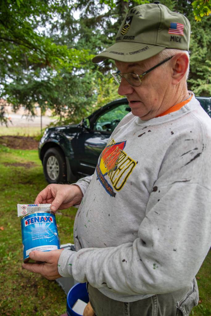 Marion Mick Hersey explains how to use a specific epoxy to affix headstones to basestones in a cemetery preservation. He said the epoxy would last forever. Hersey, National Historical Preservationist, came from Kitsap County to help other volunteers in a restoration effort at Sequims Pioneer Memorial Park. Sequim Gazette photo by Emily Matthiessen