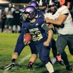 Sequim running back Sam Fitzgerald looks for running room in the Wolves 49-7 loss to North Kitsap on Oct. 8. Fitzgerald led Sequim with 88 rushing yards.