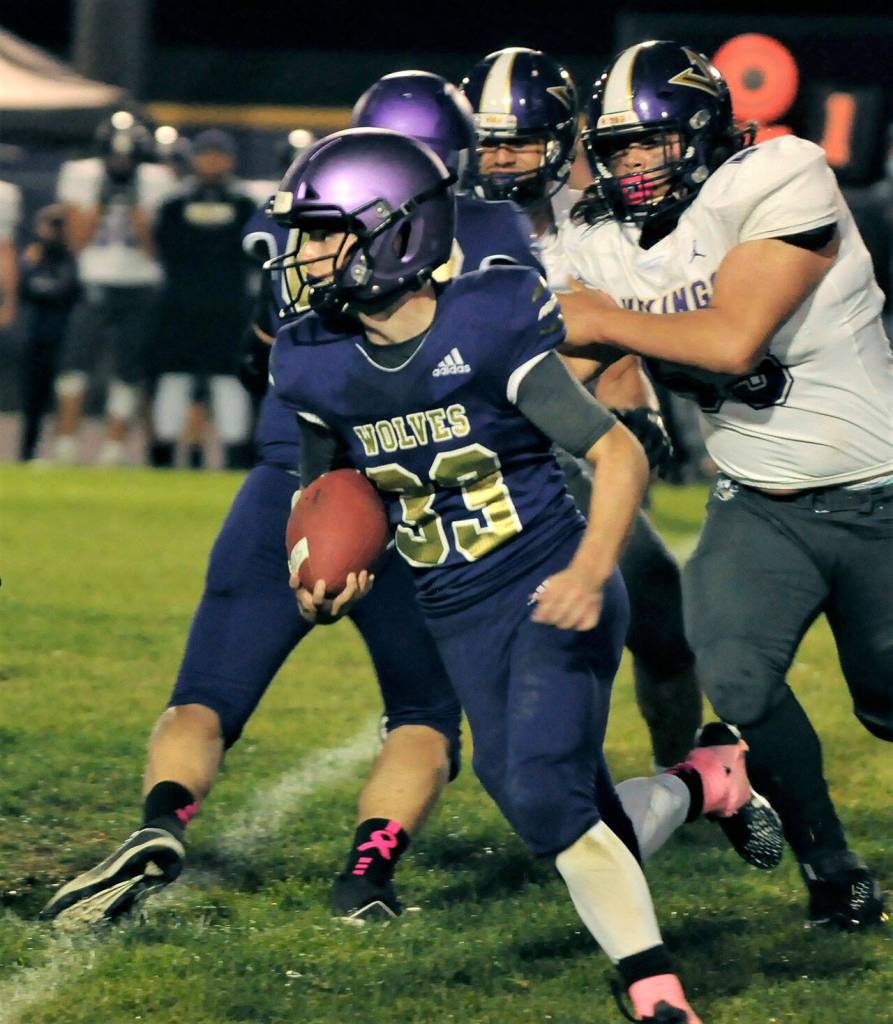 Sequim running back Sam Fitzgerald looks for running room in the Wolves 49-7 loss to North Kitsap on Oct. 8. Fitzgerald led Sequim with 88 rushing yards.