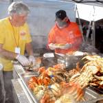 Crab Crew members Dan Schulz of Sequim, left, and Marcus Giunderson of Port Angeles assemble crab dinners at the main tent of the Dungness Crab and Seafood Festival on Oct. 8 in Port Angeles. Photo by Keith Thorpe/Olympic Peninsula News Group
