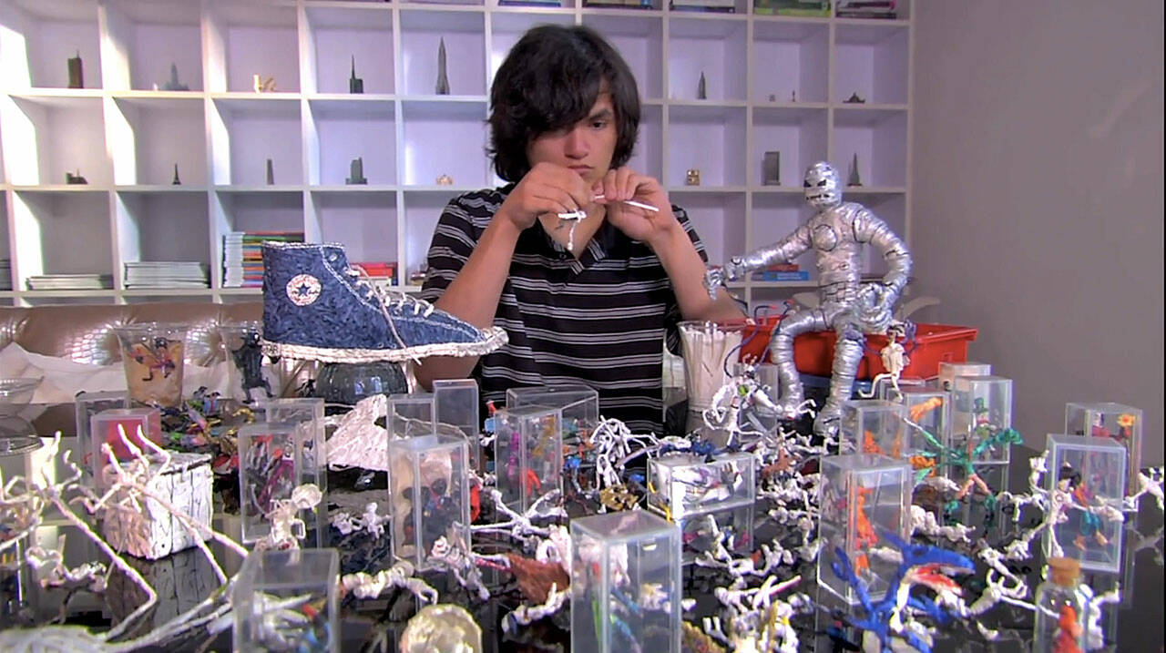 Brian Tolley works surrounded by his art created from twist-ties in Mr. Twister, a film about a teen with autism who wanted to combat how people were treating him differently from others. Screenshot courtesy of Sproutflix
