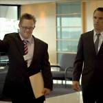 In the film The Interviewer, James Dexter (portrayed by Gerard Odwyer) ushers an unsure Thomas Howell (portrayed by Winston Cooper) into a meeting room to conduct a job interview. Screenshot courtesy of Sproutflix