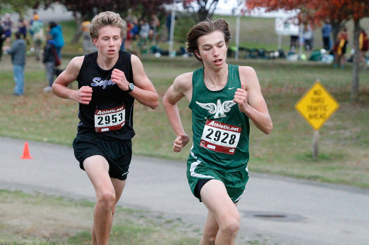 Port Angeles Max Baeder, right, edges Sequims Colby Ellefson for medalist honors at an Olympic League meet on oct. 13 at Bainbridge Islands Battle Point Park. Photo by Mark Krulish/Kitsap News Group