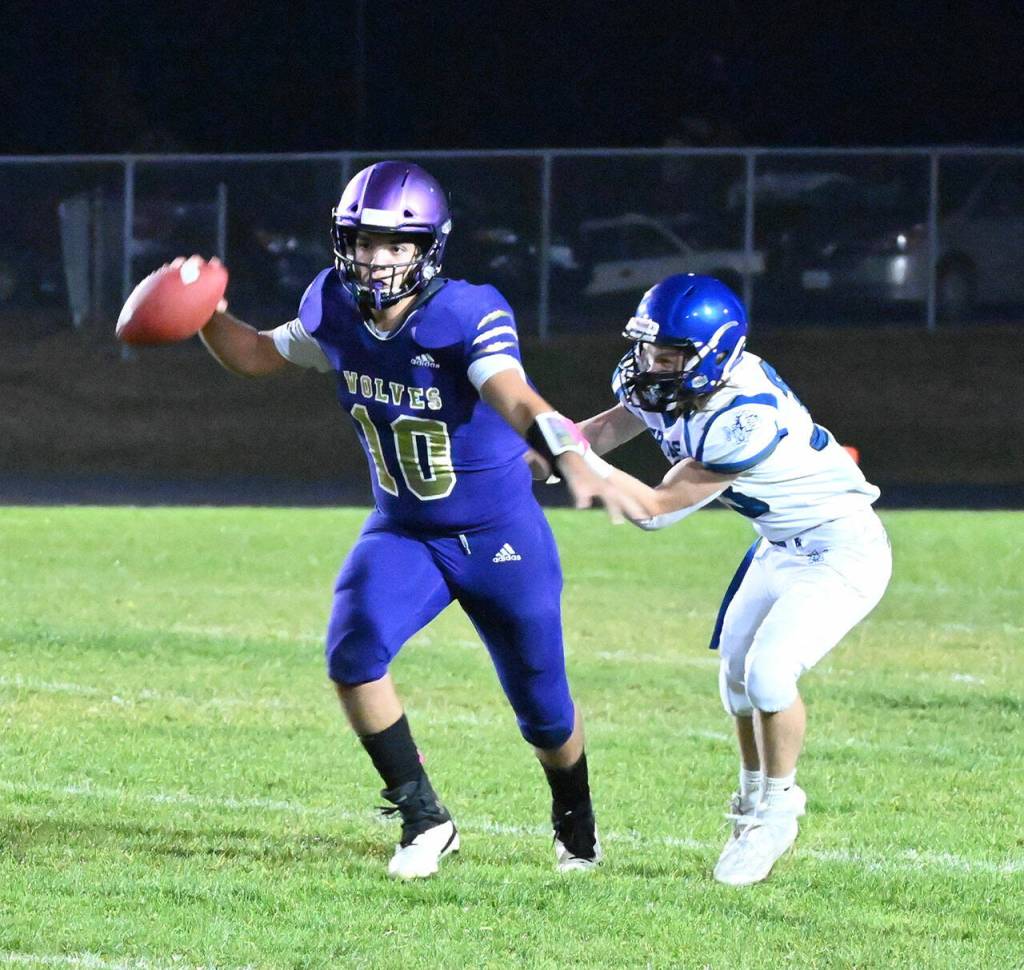 Sequim quarterback Lars Wiker tries to escape a sack in the second half of the Wolves 29-28, come-from-behind win. Sequim Gazette photo by Michael Dashiell