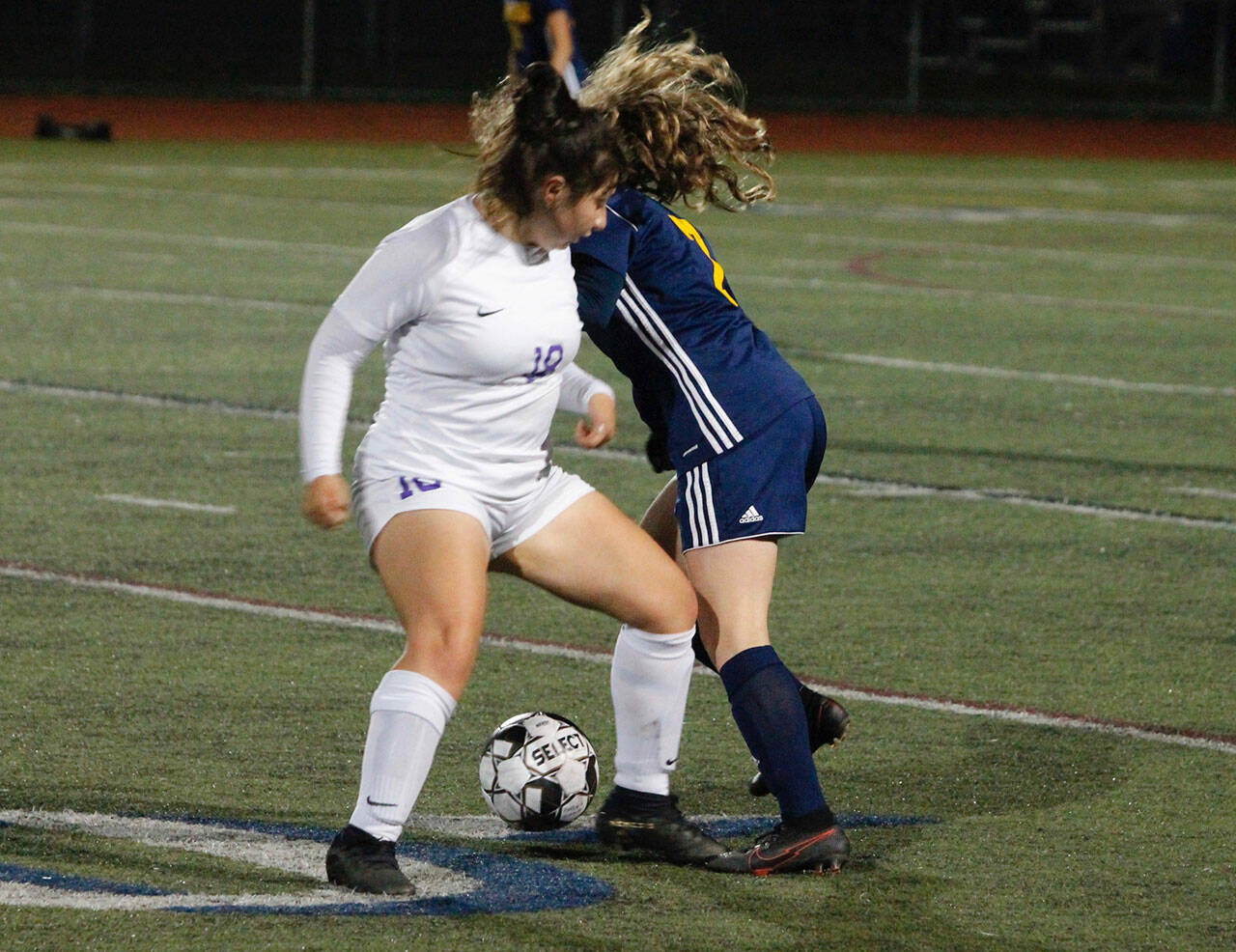 Sequims Samantha Gonzalez, left, gets tangled up with Bainbridges Gabby Weis at midfield in an Olympic League game on Oct. 14. Bainbridge edged Sequim, 1-0. Photo by Mark Krulish/Kitsap News Group