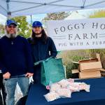 From left, Foggy Hog Farm owner Alex Lemay and crew members Sage Vann and Cole Dotson are ready to greet customers at the Sequim Farmers & Artisans Market Saturday. Photo by Emma Jane Garcia